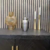 A silver cremation urn for ashes on display for sale online at a perth funeral home