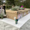 a decorating ceremony with a cardboard daisybox coffin just before a funeral service in perth